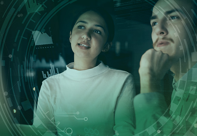 two people observing computer screen with tech graphics